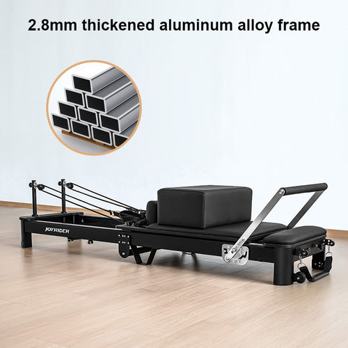 Black exercise reformer with 2.8mm thick aluminum alloy frame on a light wooden floor.