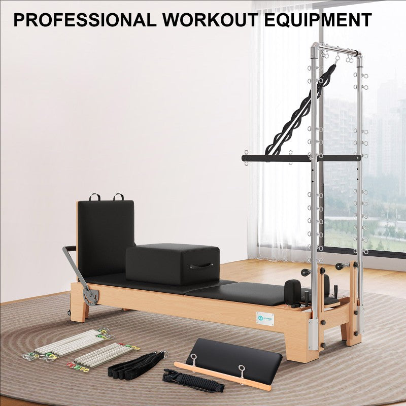 Joyrider Pilates Reformer with Half Tower Semi-elevated core bed Pilates reformer machine with accessories on a wooden floor in a room with large windows.