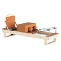 Premium H108 Pilates reformer with terracotta cushions and maple wood frame, three-quarter view