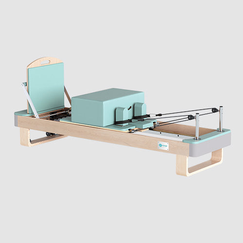 Joyrider Pilates reformer with maple wood frame and adjustable resistance springs